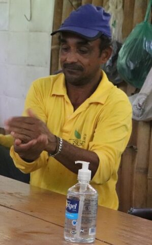 Homem higienizando a mão com álcool